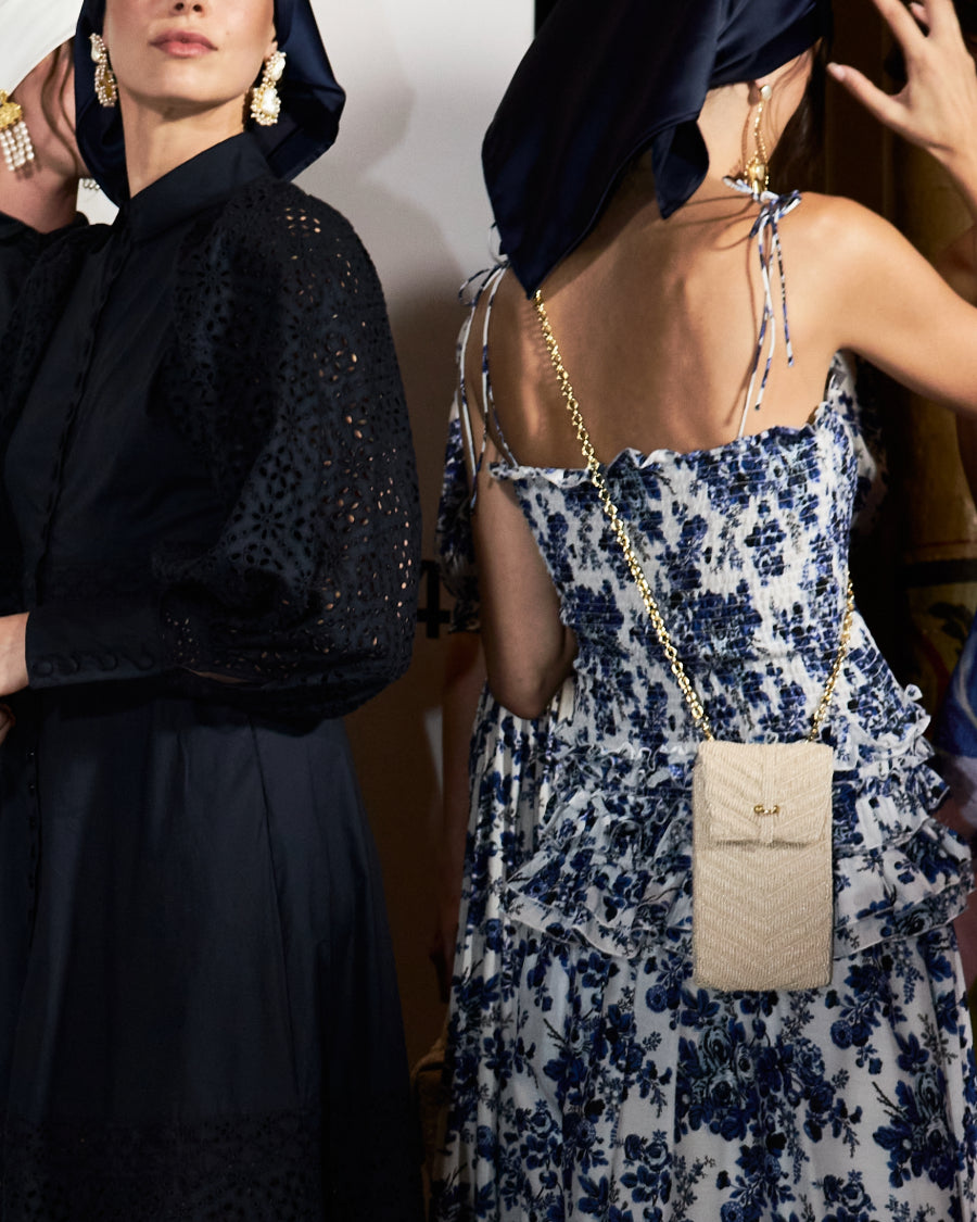 Two models at an event styling the white Graceful Cascades mini bag, showcasing it as a perfect bridal or celebration accessory.