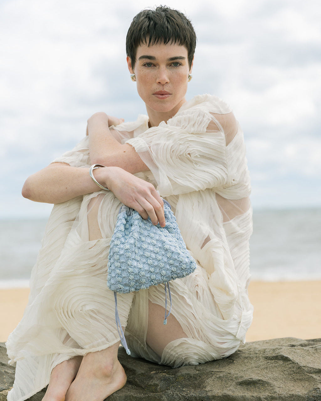 Model holding His Eyes blue beaded bag, evening occasion handbag