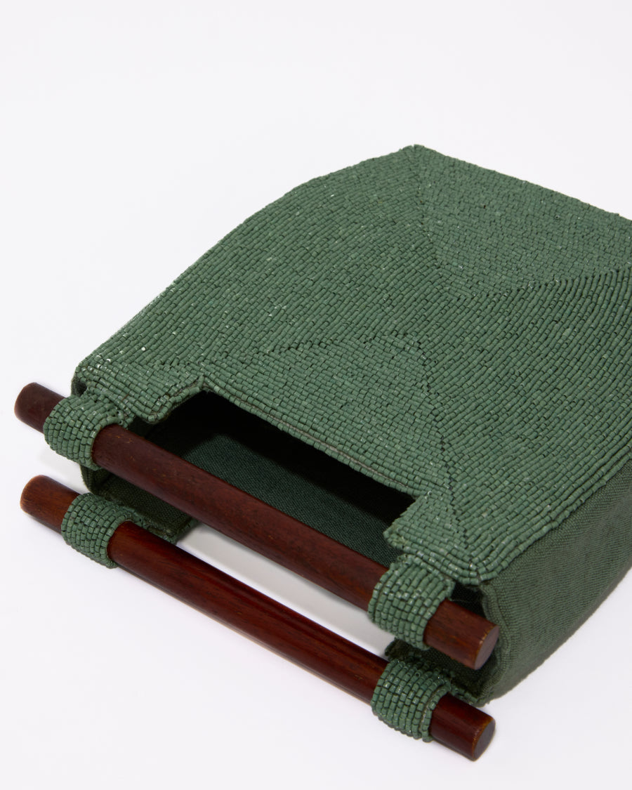 Side profile of the jade green Reach for Words bag showing its structured 5cm depth and the intricate hand-beaded texture