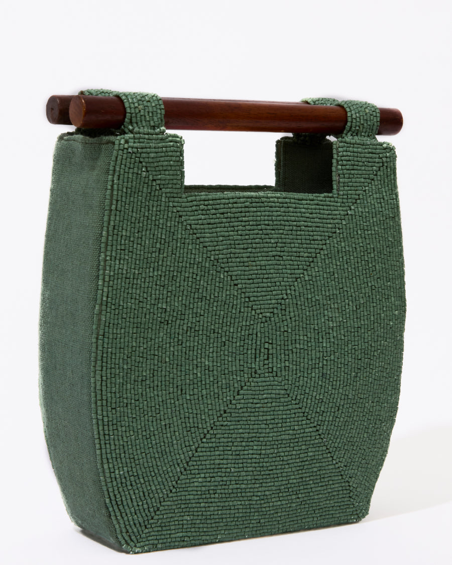 Straight-on studio view of the jade green Reach for Words beaded bag, highlighting the symmetrical minimalist design and wooden handles