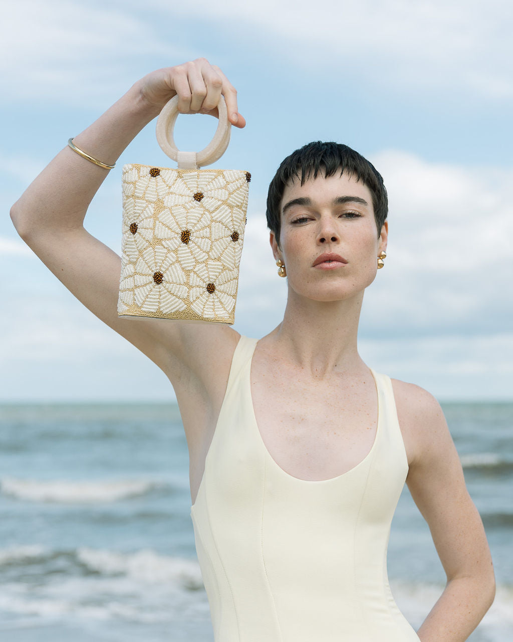 Model at the beach holding the &