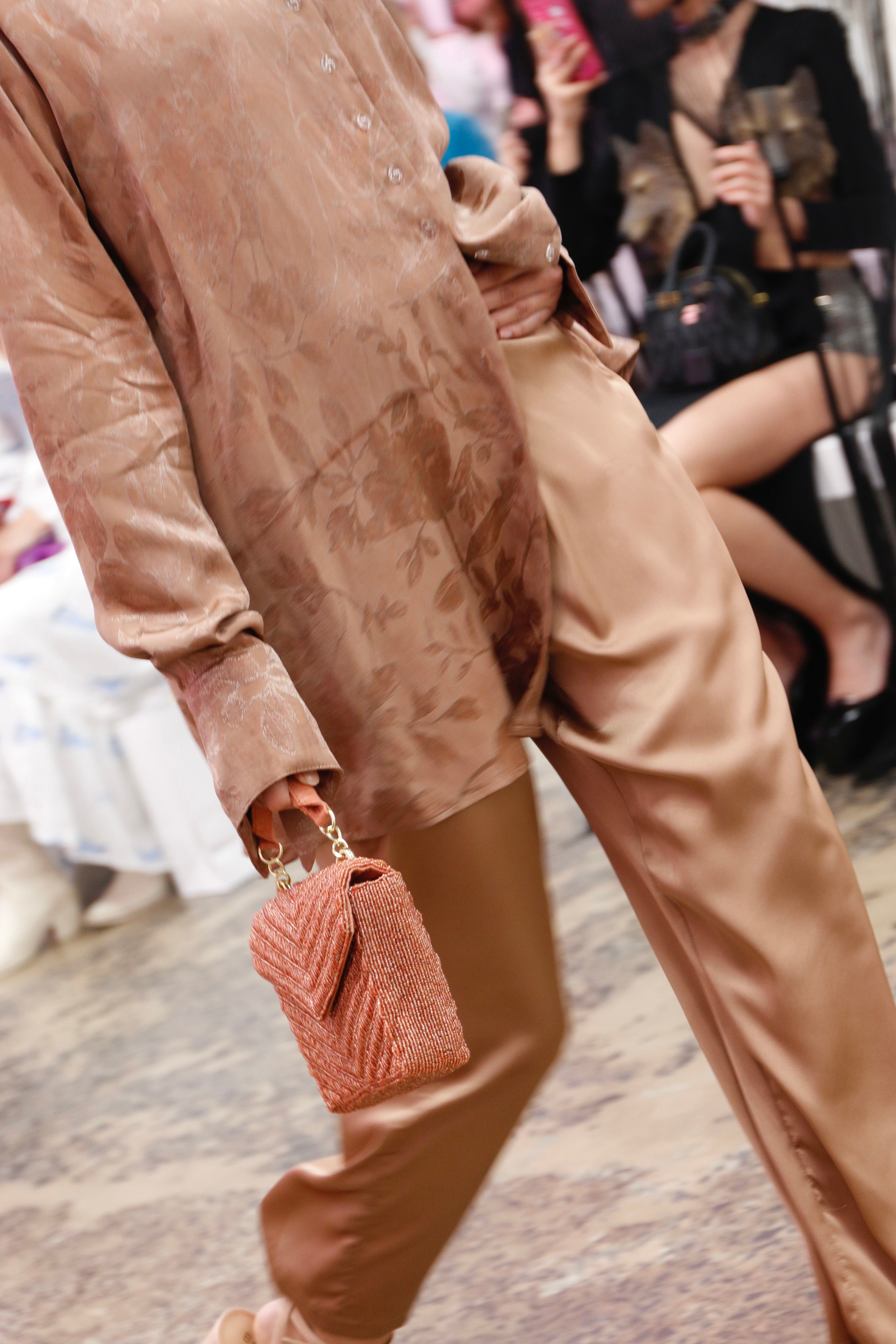 Artistic lifestyle shot of the peach chevron beaded bag, showcasing it as a trendy statement piece for modern evening wear.