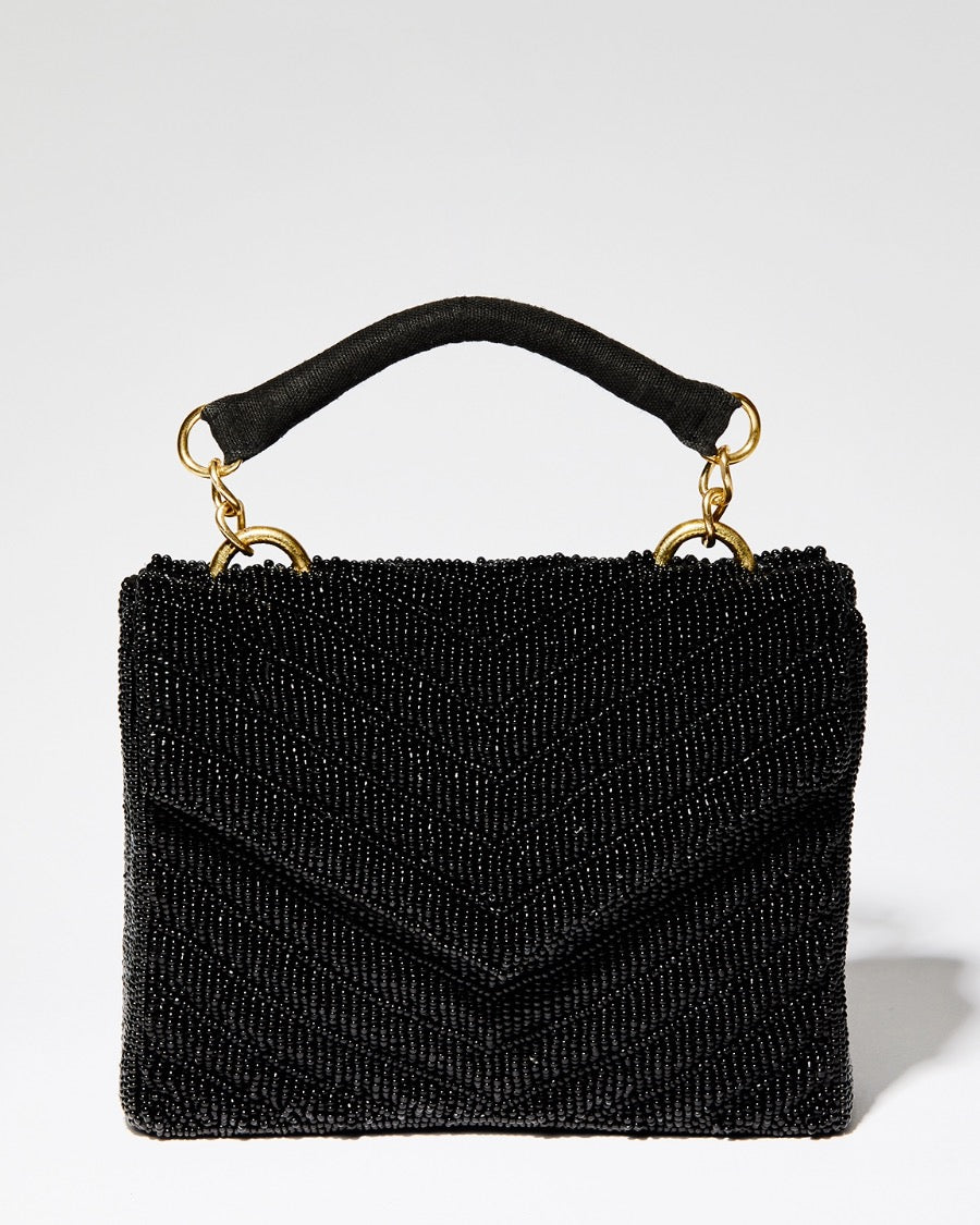 Front view of the Waves Never Cease black beaded bag highlighting the symmetrical artisan chevron pattern and magnetic closure flap.