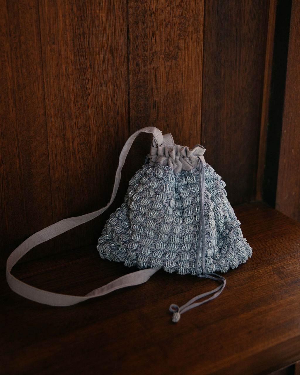 His Eyes beaded bag in blue product sitting on shelf