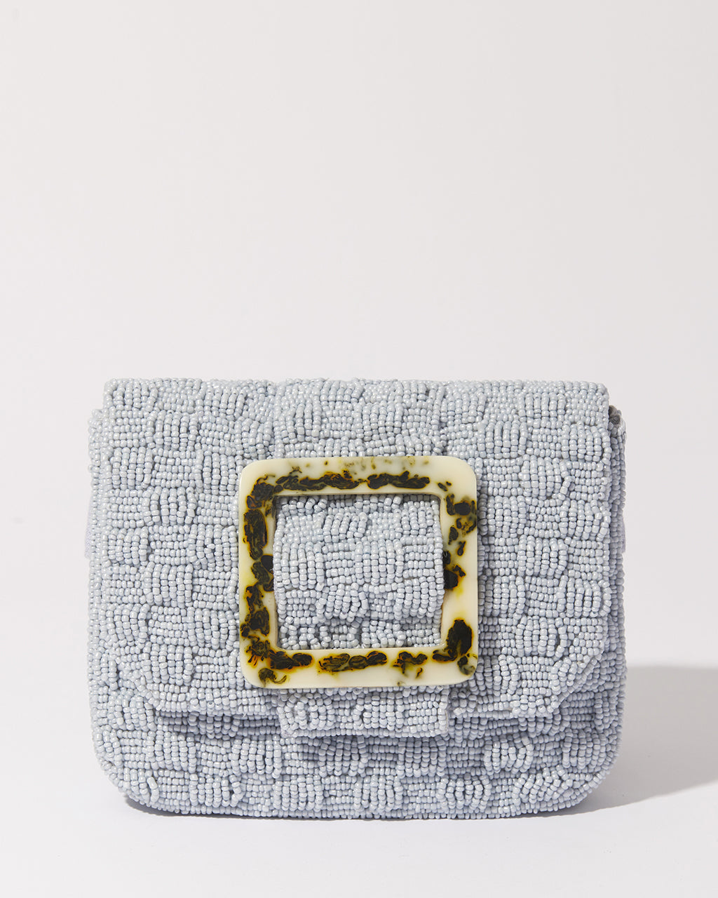 Studio flat lay of the Uncovered Layers beaded bag with its adjustable jute strap, demonstrating its function as a trendy crossbody or waist bag