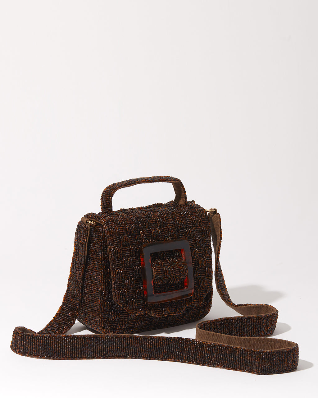 Three-quarter studio view of the Uncovered Layers rich brown beaded bag featuring a layered woven design and glossy resin buckle.