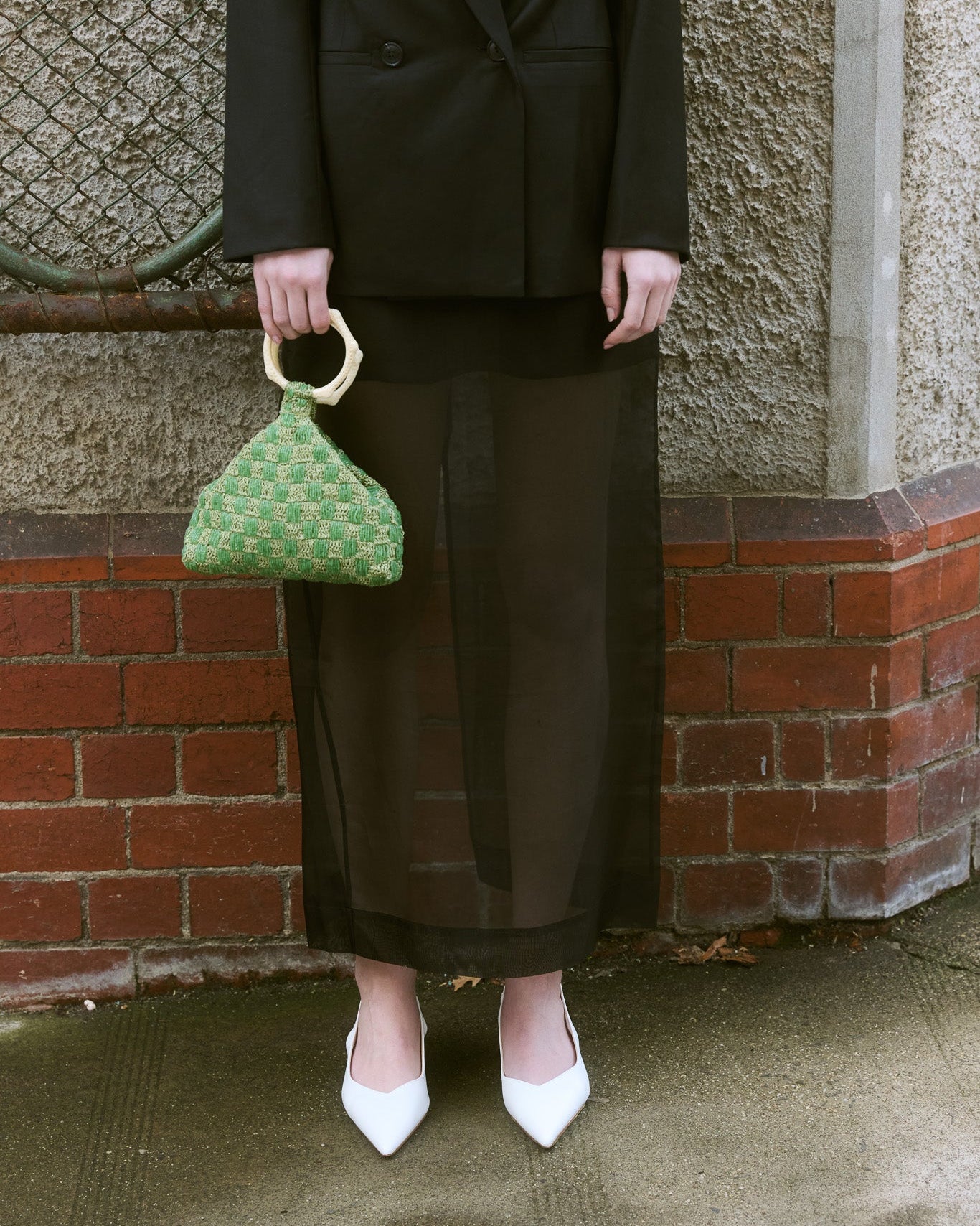 Green beaded handbag with woven check design and sculptural ivory top handle by The Hold.