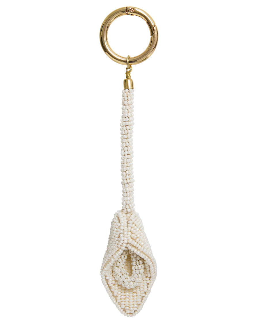 Hand-threaded ivory beaded keychains from The Hold label, featuring a floral motif and gold-tone hardware.