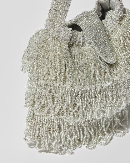 Silver beaded Tassel bag with layered fringe and beaded flap closure close up view.