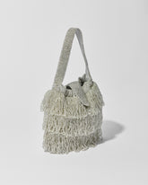side view of Mira Silver beaded Tassel bag with layered fringe, top strap by the hold 