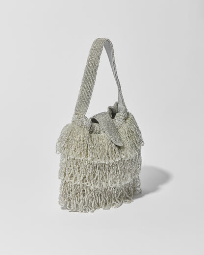 side view of Mira Silver beaded Tassel bag with layered fringe, top strap by the hold 