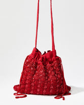 Full view of the As Always pouch in red with its matching long beaded drawstrings and a detachable 110cm crossbody strap.
