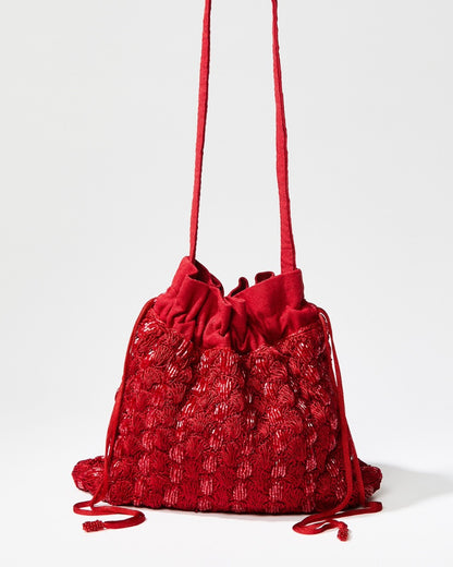 Full view of the As Always pouch in red with its matching long beaded drawstrings and a detachable 110cm crossbody strap.