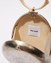 Internal view of the open metal bag showing the natural jute lining and enough space to fit an iPhone Plus and evening essentials.