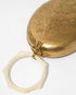 Close-up of the Capacity for Presence bag in gold, showcasing the organic hand-beaten texture of the gold brass and the detailed metal clasp.