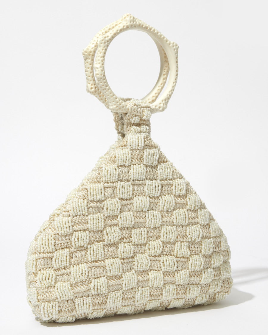 Intimate Exchange ivory beaded handbag, designer statement bag, angled view. Wedding bag with pearl detail 