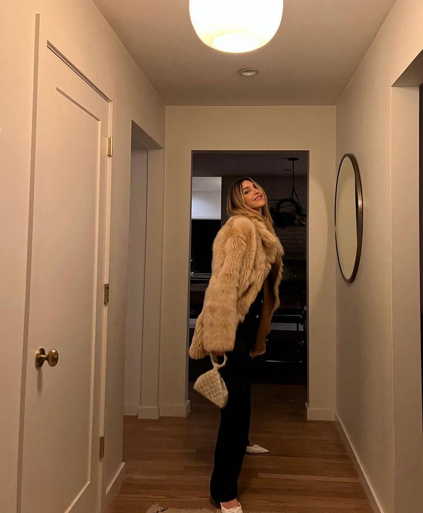 Model holding Intimate Exchange bag in ivory, beaded occasion bag for eBridal, wedding and events  with pearl detail.