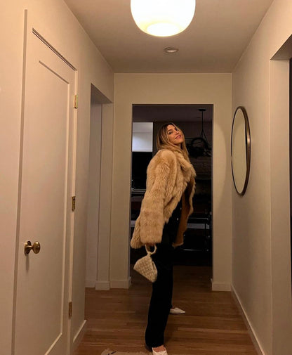 Model holding Intimate Exchange bag in ivory, beaded occasion bag for eBridal, wedding and events  with pearl detail.