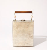 Straight-on view of the Modern World brass bag, illustrating its ability to function as both a handbag and a beautiful home ornament.