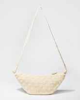 Front studio view of the Moving Through cream beaded bag featuring a sculptural curved silhouette and handcrafted beaded crochet texture.