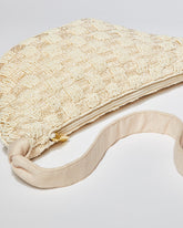 High-angle view of the cream Moving Through bag highlighting the natural cotton strap and the intricate pattern of hand-dyed glass beads.