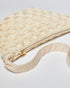 High-angle view of the cream Moving Through bag highlighting the natural cotton strap and the intricate pattern of hand-dyed glass beads.