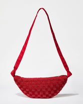 Front studio view of the Moving Through red beaded bag featuring a sculptural curved silhouette and handcrafted beaded crochet texture.