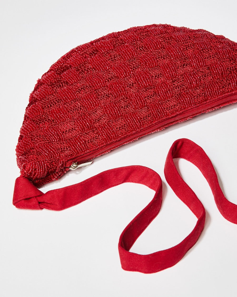 Top-down view of the red Moving Through bag showcasing the natural cotton strap and the intricate pattern of hand-dyed glass beads