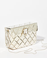 Angled view of the silver metal bag highlighting the detailed shell clasp with a Baroque pearl feature and the removable gold chain strap.