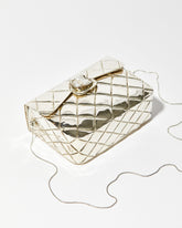 High-angle view of the silver metal bag showing the intricate individually shaped shell clasp and the high-shine quilted metal finish.