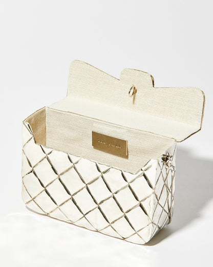 Open view of the silver metal bag showing the natural jute lining and internal space designed to fit an iPhone Plus.