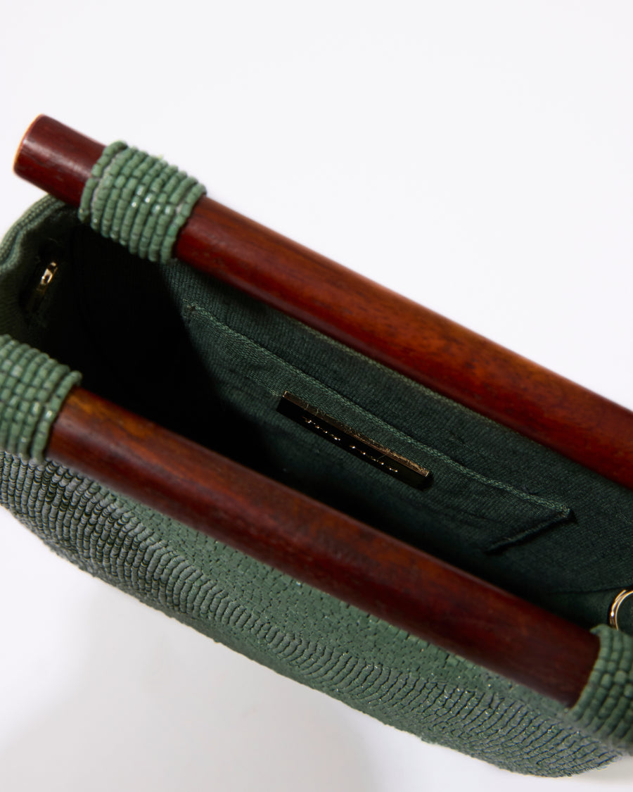 Top-down view into the open jade green beaded bag, showcasing the natural jute lining and internal storage space.