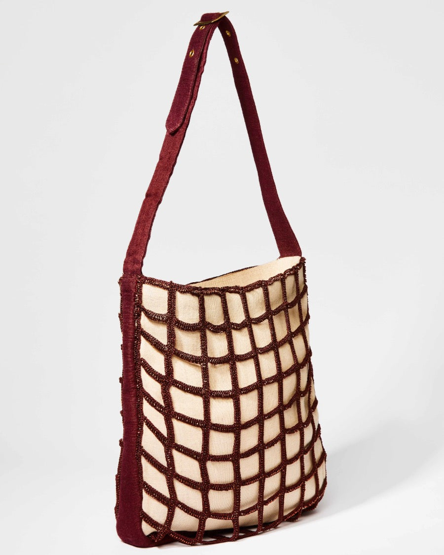 Side profile of the Returning Form tote highlighting the 4cm depth and the adjustable jute shoulder strap with gold buckle detail.