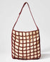Returning Form tote bag in burgundy by The Hold, a handcrafted sustainable bag made from natural canvas and a knotted grid.