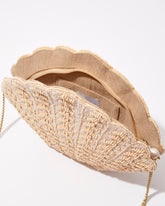 Open view of the shell-shaped beaded clutch showing the natural jute lining and internal space for an iPhone Plus and bridal essentials.