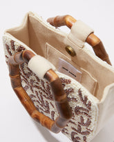 Side profile of the Symbolic Path beaded bag showing its structured 6cm depth and the triangular sculptural silhouette.