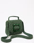 Three-quarter studio view of the Uncovered Layers jade green beaded bag featuring a sculptural woven design and green resin buckle.