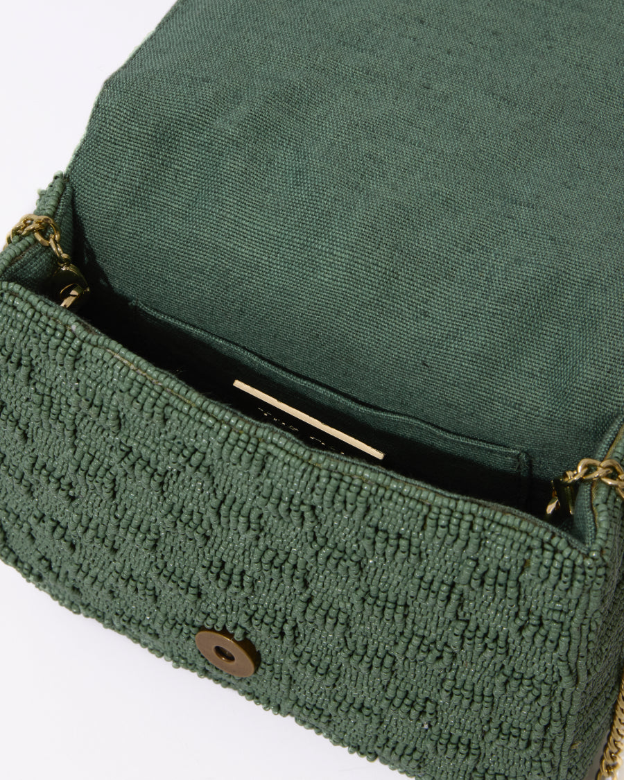 Open view of the jade green beaded bag showing the natural jute lining and spacious interior that fits an iPhone Plus and essentials