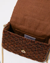 Open view of the brown Uncovered Layers bag showing the natural jute lining and spacious interior that fits an iPhone Plus and essentials.