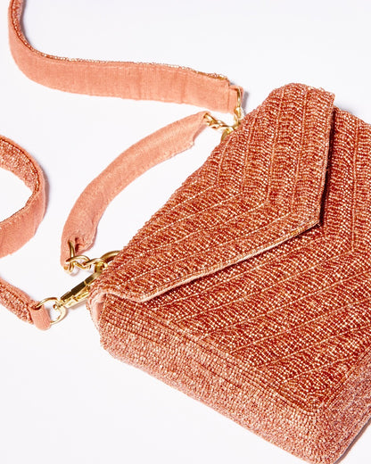 Flat studio shot of the Waves Never Cease bag in apricot with its 110cm removable beaded crossbody strap fully displayed.