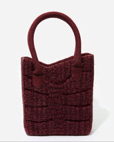 A straight-on studio shot of the artisan-made Wonder Before Why beaded bag, showing the symmetry of the handcrafted beadwork.