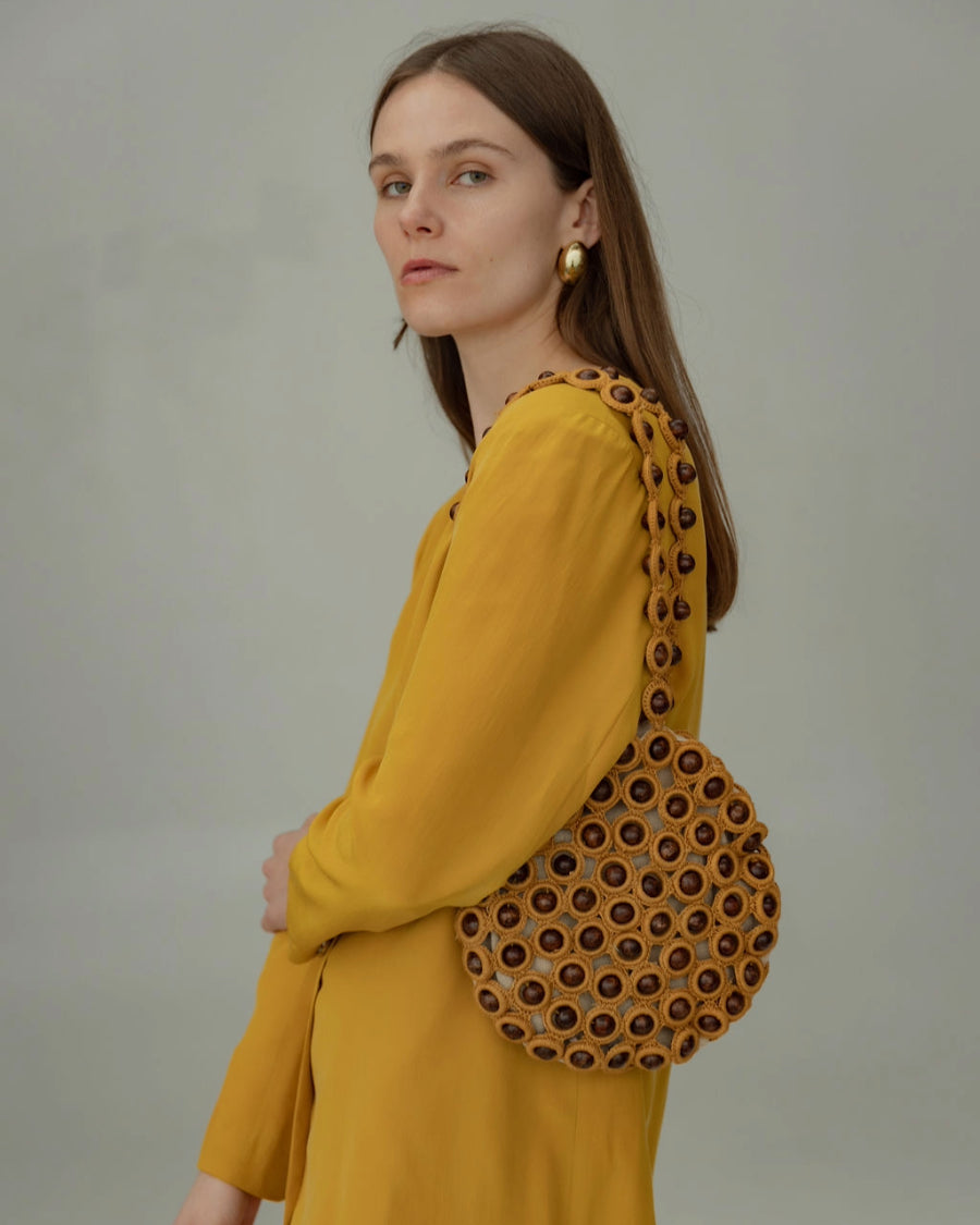 Model in a yellow blazer styling the &