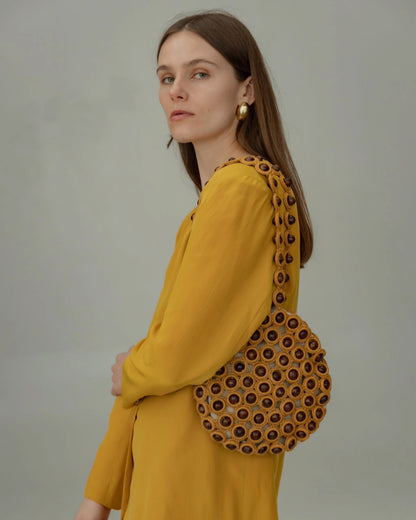 Model in a yellow blazer styling the &