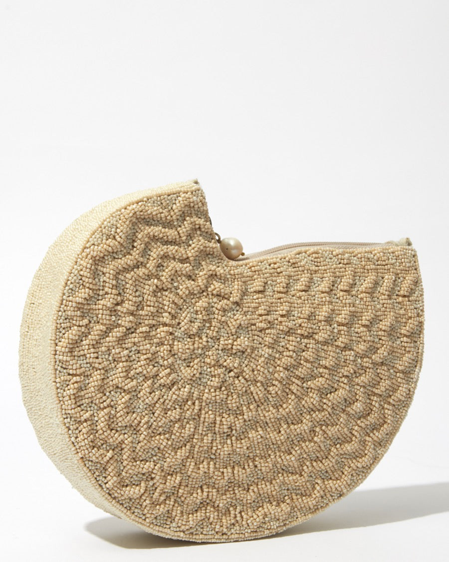 Side profile of the Beyond Us beaded clutch emphasising the 5cm depth and the clean, curved lines of the handcrafted beaded body.