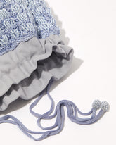 Close-up of His Eyes blue beaded bag showing beadwork texture and drawstring detaill.