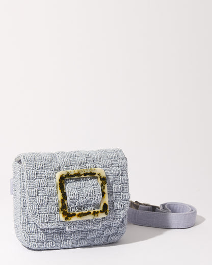 Front view of the Uncovered Layers blue beaded belt bag highlighting the distinctive woven beadwork and complementary tortoise-shell resin buckle.