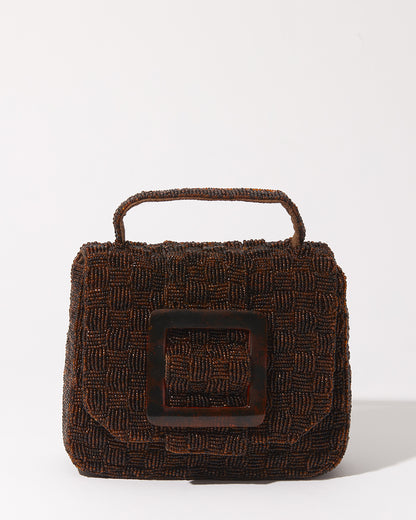 A straight-on studio view of the rich brown beaded bag showcasing the sculptural woven construction and modern resin buckle closure.